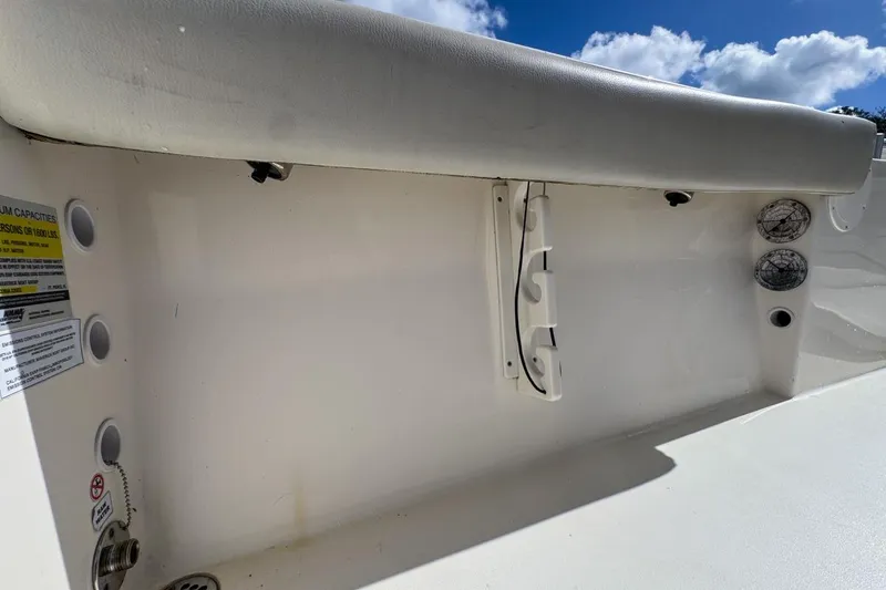 Slide: The Image of 2022 Cobia 220 Center Console boat interior with seating and storage features. - 88