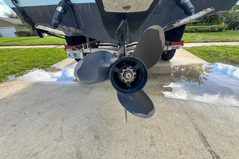 Slide: The Image of Rear view of 2022 Cobia 220 Center Console boat propeller on a trailer. - 9