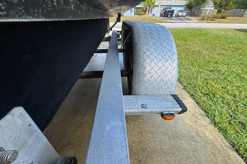 Slide: The Image of Trailer view of 2022 Cobia 220 Center Console boat on driveway. - 98