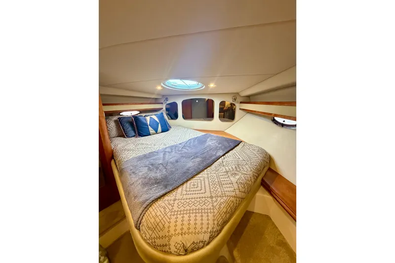 Slide: The Image of Luxurious cabin interior of 2007 Cruisers Yachts 370 Express with cozy bedding. - 15