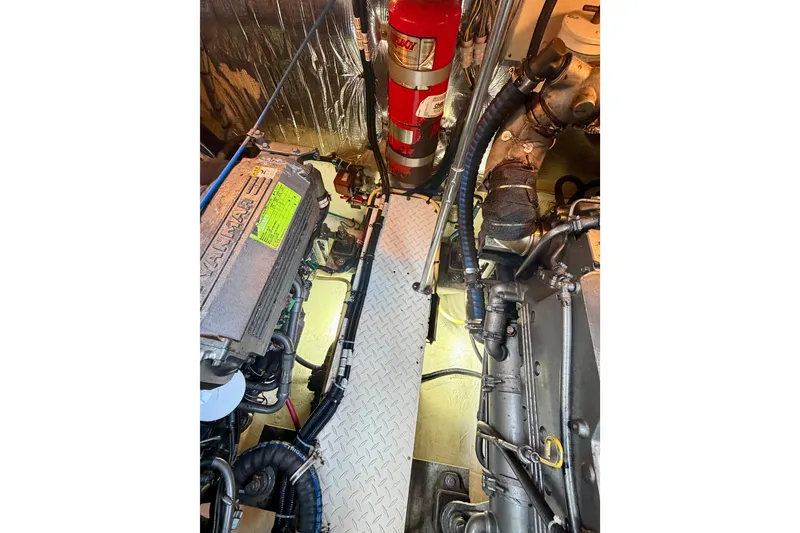 Slide: The Image of Engine room of 2007 Cruisers Yachts 370 Express with visible Yanmar engine and fire extinguisher. - 17