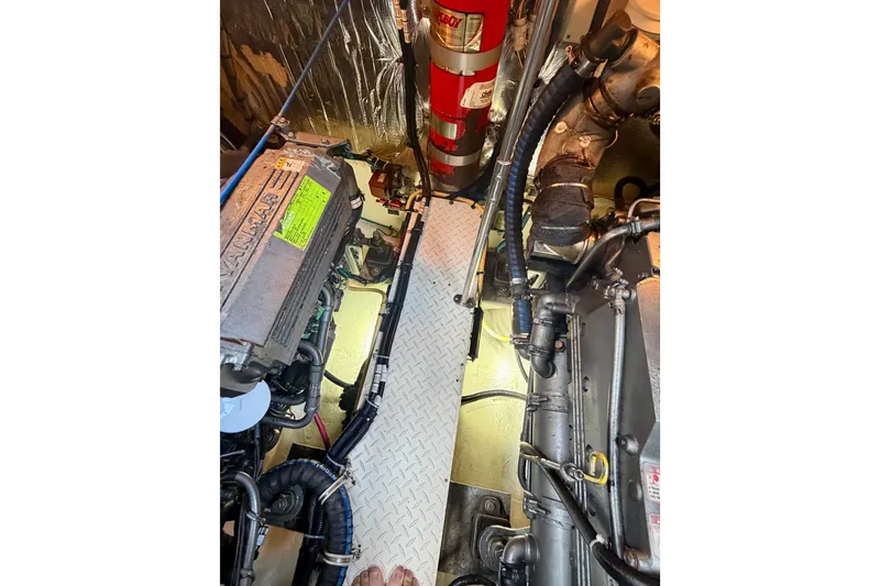 Slide: The Image of Engine room of 2007 Cruisers Yachts 370 Express with visible machinery and fire extinguisher. - 18