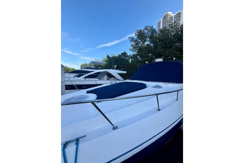 Slide: The Image of 2007 Cruisers Yachts 370 Express docked, featuring sleek design and blue canopy. - 4