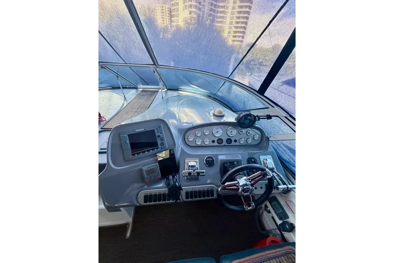 Slide: The Image of 2007 Cruisers Yachts 370 Express helm with navigation controls and steering wheel. - 5
