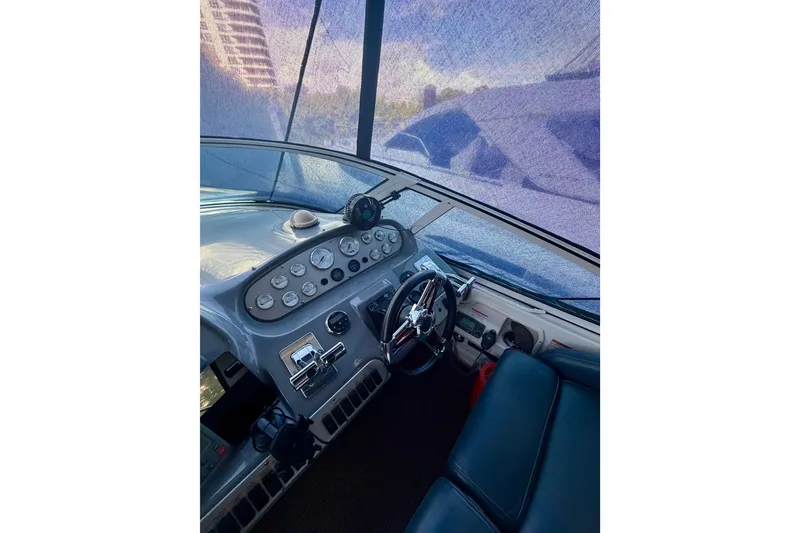 Slide: The Image of 2007 Cruisers Yachts 370 Express helm with steering wheel and control panel. - 6