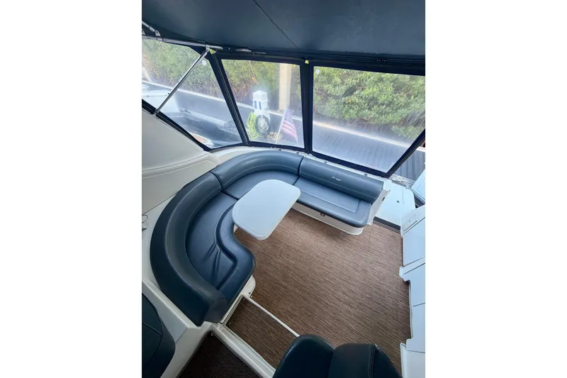 Slide: The Image of 2007 Cruisers Yachts 370 Express interior with curved seating and table. - 7