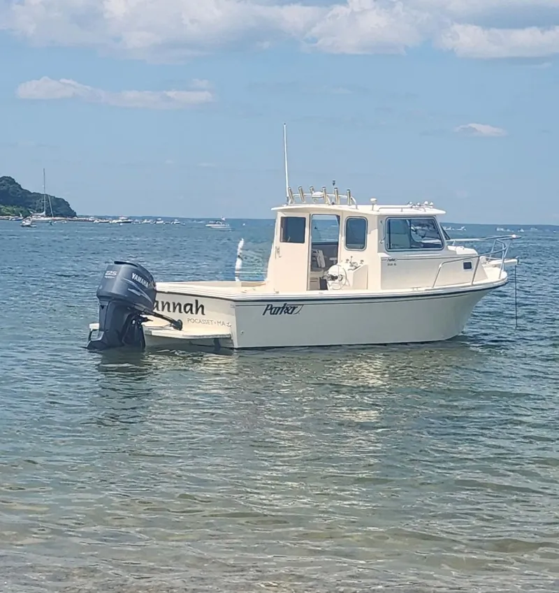 Slide: The Image of 2002 Parker 2520 XL Sport Cabin boat in calm waters. - 1