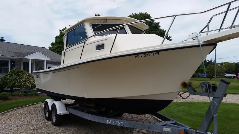 Slide: The Image of 2002 Parker 2520 XL Sport Cabin on trailer in front of house. - 2