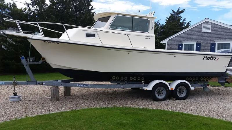 Slide: The Image of 2002 Parker 2520 XL Sport Cabin on trailer in front of house. - 3
