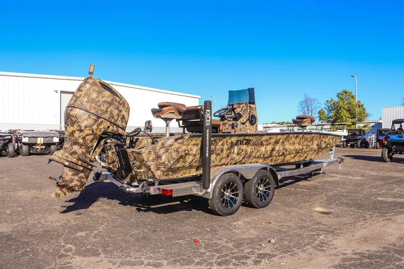 Slide: The Image of 2026 Excel 220 Bay Pro Elite boat with camouflage design on a trailer. - 2
