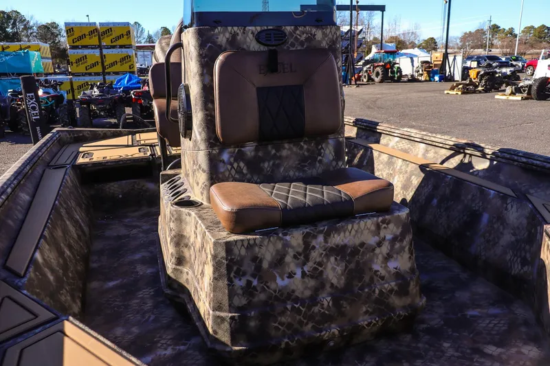 Slide: The Image of 2026 Excel 220 Bay Pro Elite boat with camo design and cushioned seating. - 8