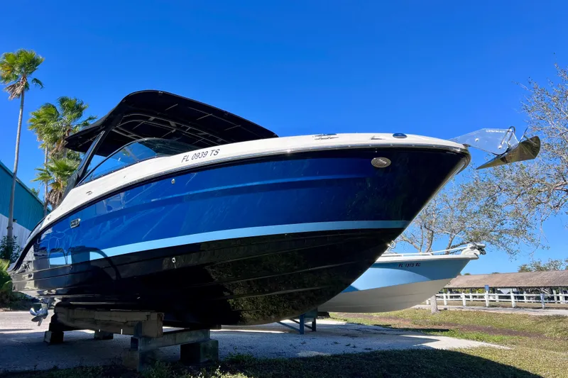 Slide: The Image of 2024 Sea Ray SLX 280 Outboard boat on display under clear blue sky. - 12