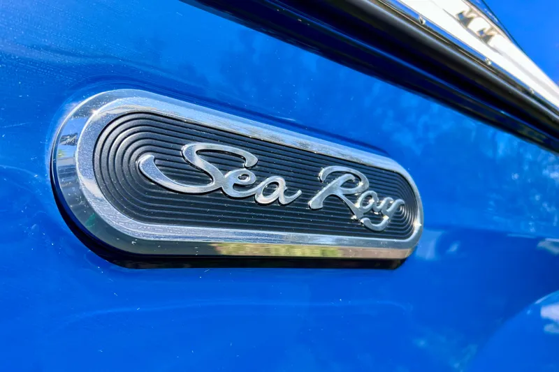 Slide: The Image of Close-up of 2024 Sea Ray SLX 280 Outboard logo on blue surface. - 13