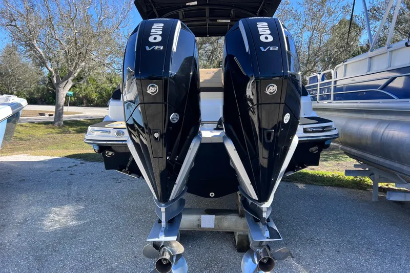 Slide: The Image of 2024 Sea Ray SLX 280 Outboard with dual 250 V8 engines, parked outdoors. - 14