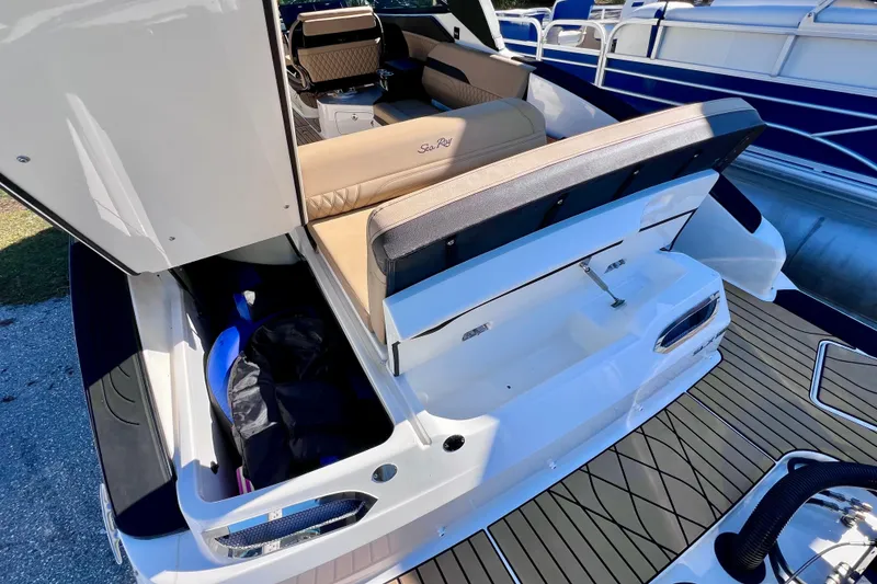 Slide: The Image of 2024 Sea Ray SLX 280 Outboard boat with open storage compartment and luxurious seating. - 20