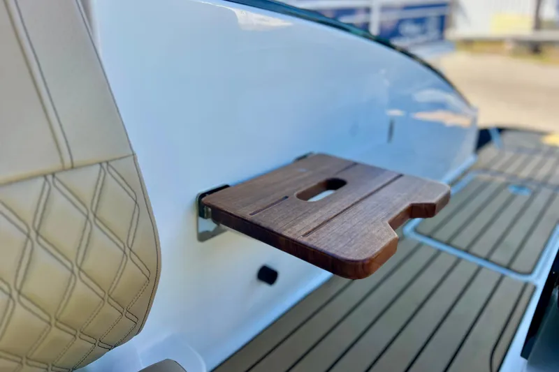 Slide: The Image of 2024 Sea Ray SLX 280 Outboard, featuring a wooden fold-out table and luxurious seating. - 26