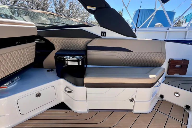 Slide: The Image of Luxurious interior of 2024 Sea Ray SLX 280 Outboard with elegant seating and cup holders. - 28