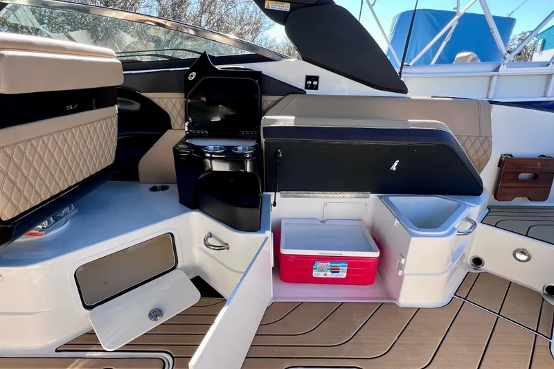 Slide: The Image of 2024 Sea Ray SLX 280 Outboard interior with seating, storage, and cooler. - 29