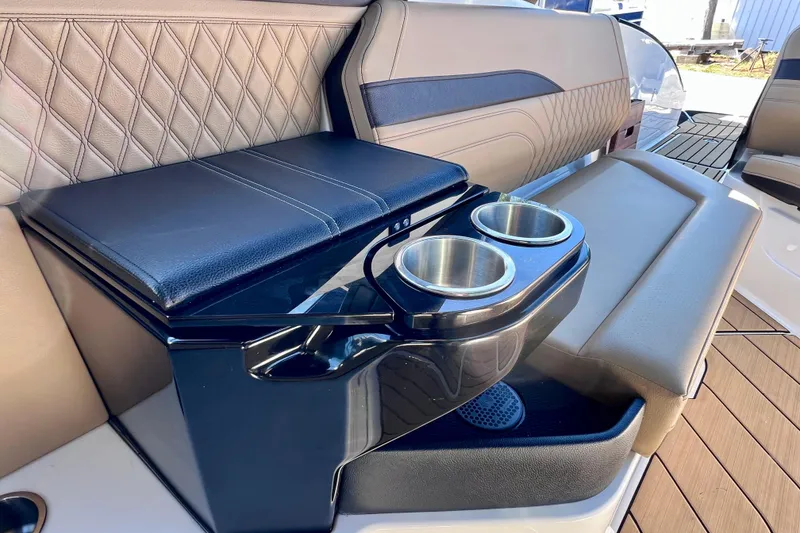 Slide: The Image of 2024 Sea Ray SLX 280 Outboard interior with luxurious seating and cup holders. - 30