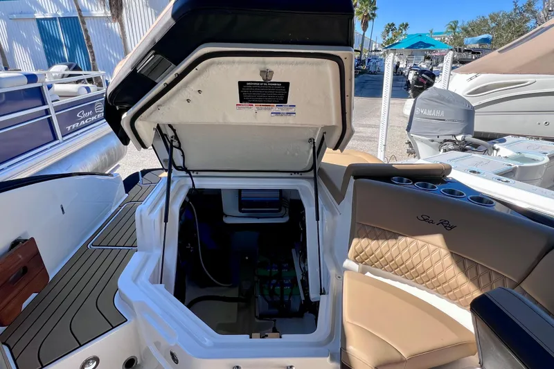 Slide: The Image of 2024 Sea Ray SLX 280 Outboard boat interior with open storage compartment. - 34