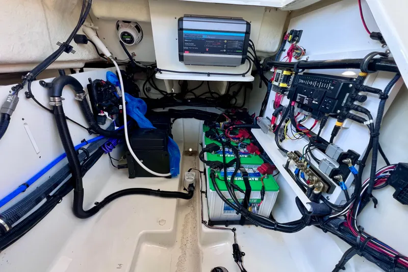 Slide: The Image of 2024 Sea Ray SLX 280 Outboard engine compartment with batteries and wiring. - 35