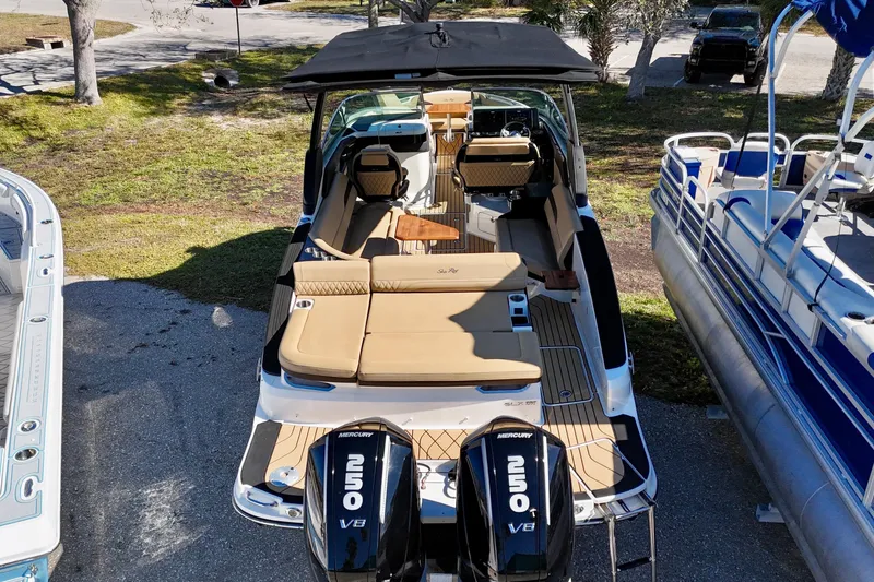 Slide: The Image of 2024 Sea Ray SLX 280 Outboard boat with twin Mercury 250 V8 engines, docked outdoors. - 4