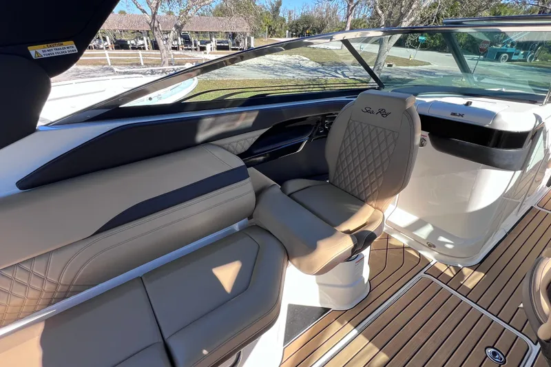 Slide: The Image of 2024 Sea Ray SLX 280 Outboard interior with tan seating and sleek design. - 41