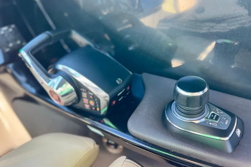 Slide: The Image of 2024 Sea Ray SLX 280 Outboard control panel with joystick and throttle. - 49