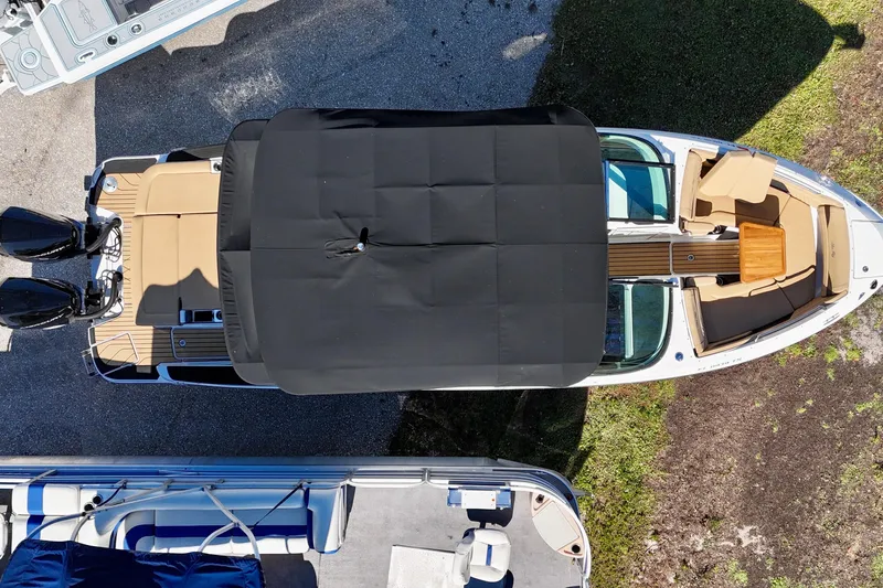 Slide: The Image of Top view of 2024 Sea Ray SLX 280 Outboard boat with black canopy and seating. - 5
