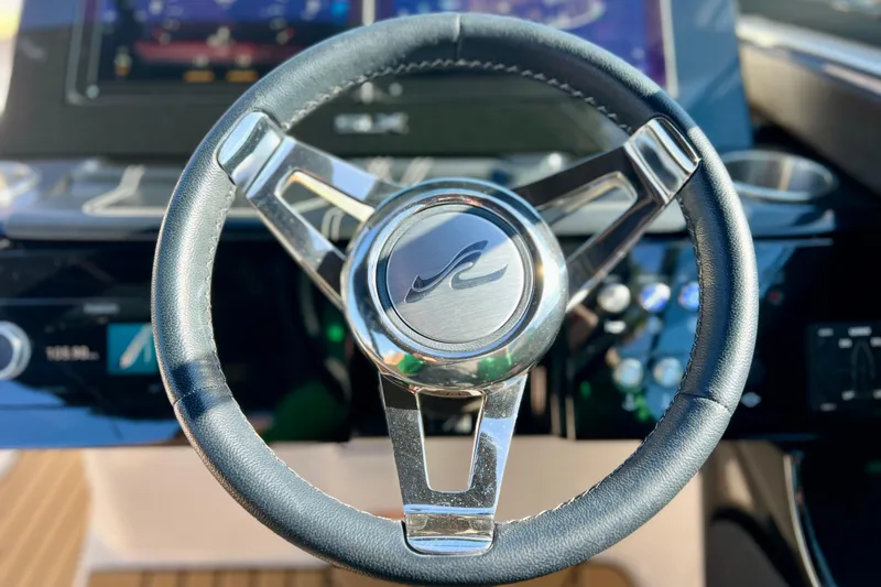 Slide: The Image of Steering wheel of 2024 Sea Ray SLX 280 Outboard boat, featuring sleek design and controls. - 51