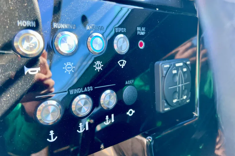 Slide: The Image of Control panel of 2024 Sea Ray SLX 280 Outboard with various function buttons. - 52