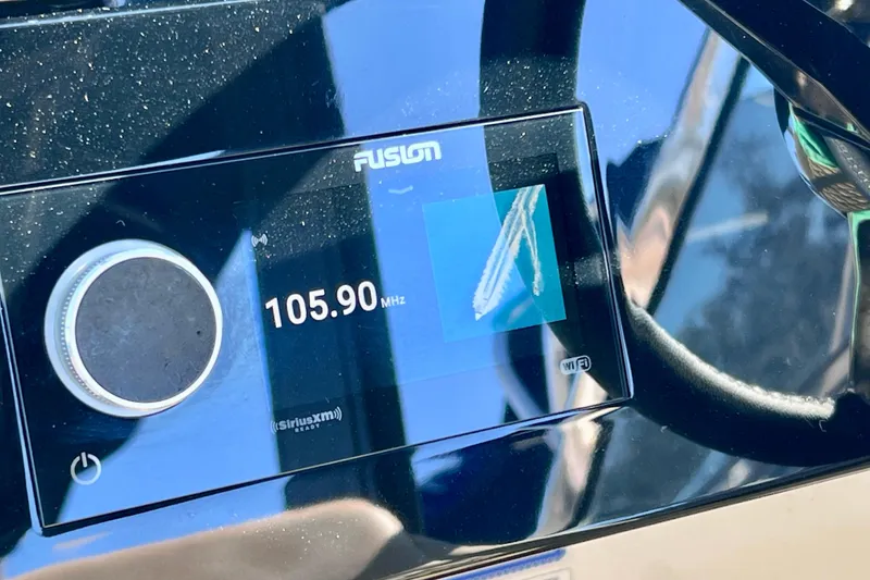 Slide: The Image of Close-up of Fusion radio display on 2024 Sea Ray SLX 280 Outboard, tuned to 105.90 MHz. - 54