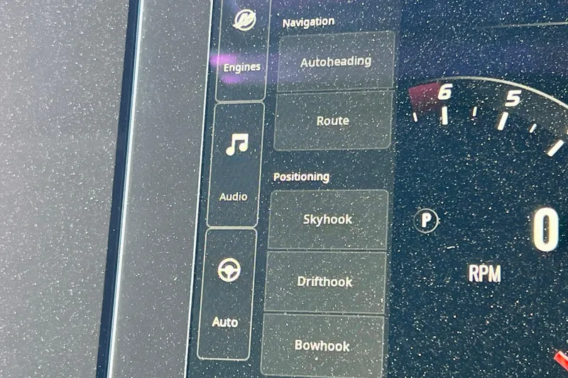 Slide: The Image of 2024 Sea Ray SLX 280 Outboard dashboard with navigation and positioning controls. - 58