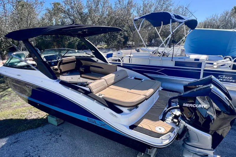 Slide: The Image of 2024 Sea Ray SLX 280 Outboard boat with Mercury engine, docked outdoors. - 6