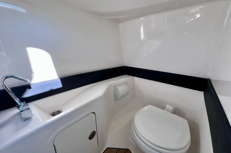 Slide: The Image of 2024 Sea Ray SLX 280 Outboard boat bathroom with modern fixtures and sleek design. - 62