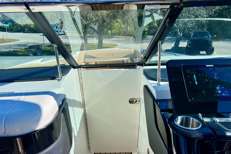 Slide: The Image of 2024 Sea Ray SLX 280 Outboard cockpit with modern dashboard and windshield view. - 64