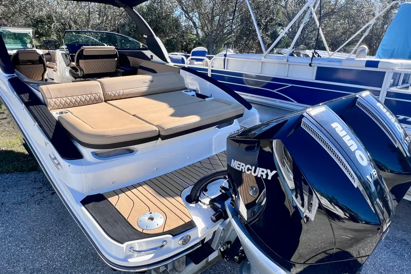 Slide: The Image of 2024 Sea Ray SLX 280 Outboard boat with luxurious seating and dual Mercury engines. - 7
