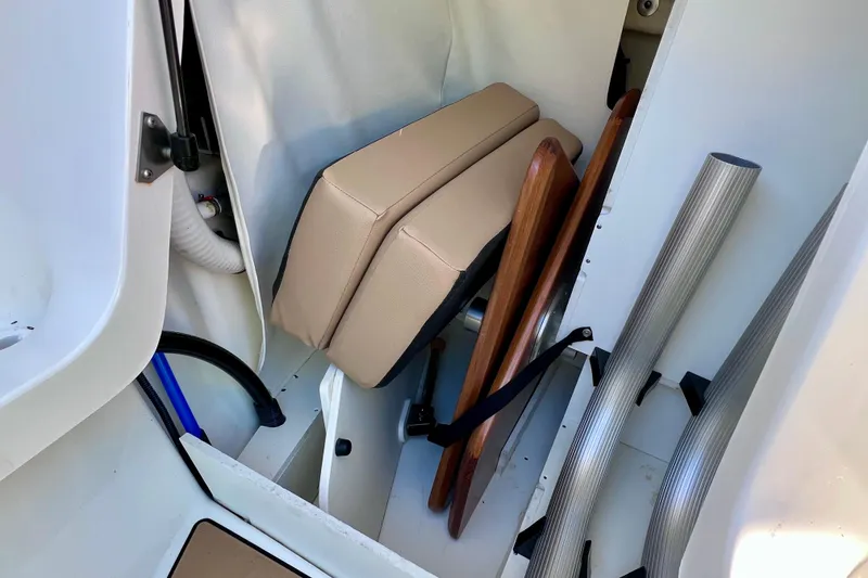 Slide: The Image of 2024 Sea Ray SLX 280 Outboard storage compartment with cushions and accessories. - 72