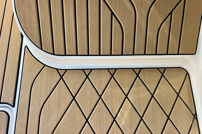 Slide: The Image of 2024 Sea Ray SLX 280 Outboard deck with elegant wood-patterned design. - 74