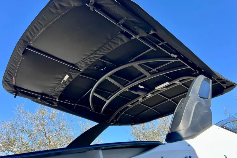 Slide: The Image of 2024 Sea Ray SLX 280 Outboard boat canopy against clear blue sky. - 76