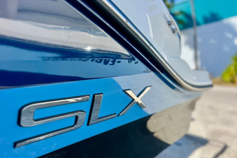 Slide: The Image of Close-up of 2024 Sea Ray SLX 280 Outboard boat logo on blue hull. - 8