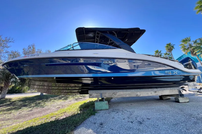 Slide: The Image of 2024 Sea Ray SLX 280 Outboard boat on display, sunny day, palm trees in background. - 9