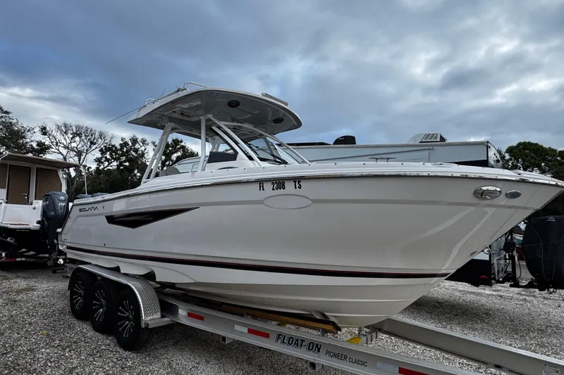 The Image of 2024 Solara S-250 CW boat on trailer, parked outdoors under cloudy sky. - 0