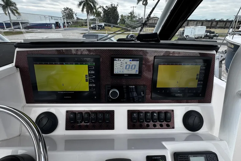 Slide: The Image of 2024 Solara S-250 CW dashboard with dual Garmin displays and control panel. - 10