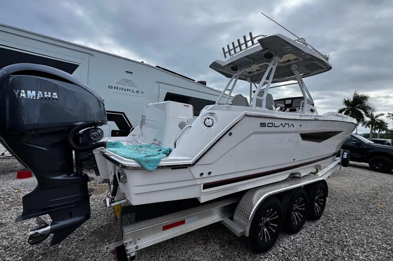 Slide: The Image of 2024 Solara S-250 CW boat on trailer with Yamaha engine, parked outdoors. - 3