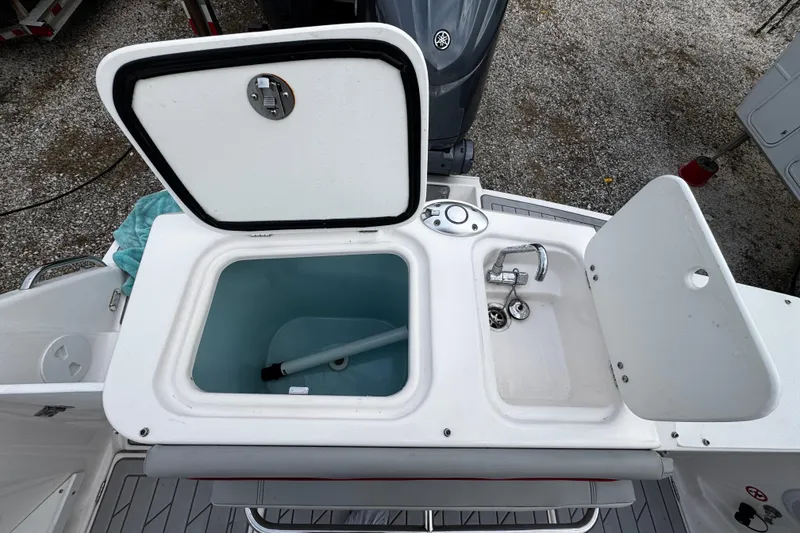 Slide: The Image of 2024 Solara S-250 CW boat sink and storage compartment, open view. - 5