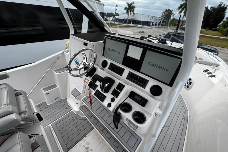 Slide: The Image of 2024 Solara S-250 CW boat cockpit with Garmin navigation displays and modern controls. - 7
