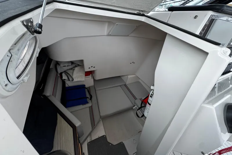 Slide: The Image of Interior cabin of 2024 Solara S-250 CW boat, featuring compact seating and storage. - 9