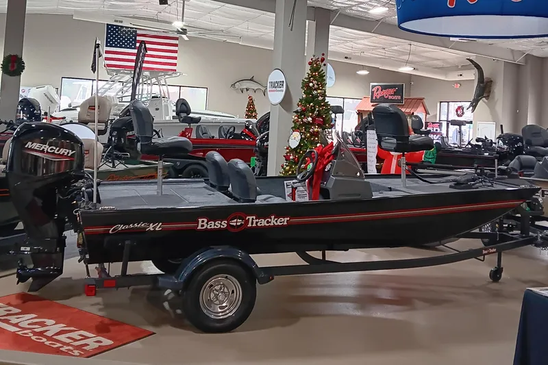 The Image of 2026 Tracker Bass Tracker Classic XL boat displayed in showroom with holiday decorations. - 0