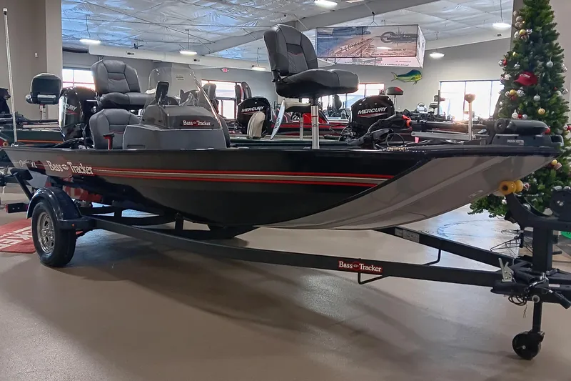 Slide: The Image of 2026 Tracker Bass Tracker Classic XL boat displayed indoors on a trailer. - 3